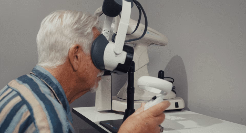A senior man takes a visual field test with Carrot