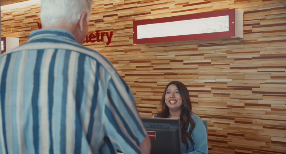 A patient checks in for his eye care appointment