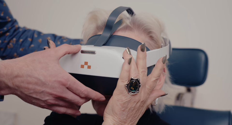 A doctor fits a patient with a Carrot headset