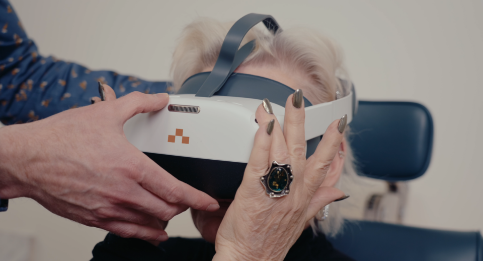 A doctor fits a patient with a Carrot headset