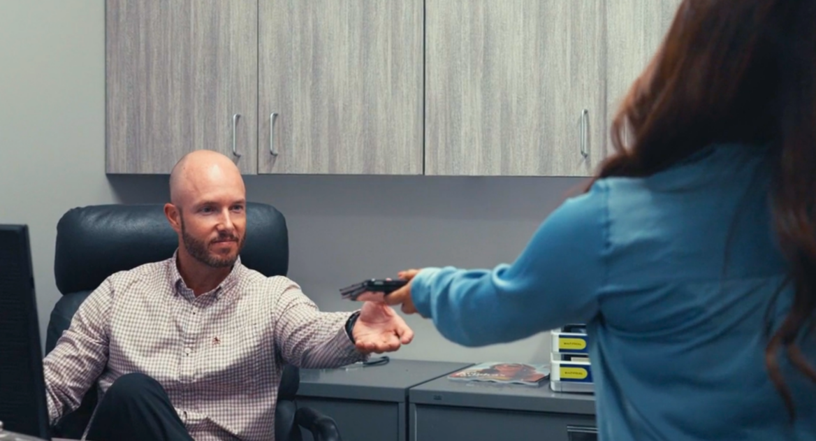 Dr. Adam Rosa takes a tablet from a technician