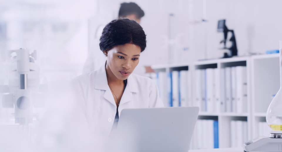 A clinical researcher looks at their computer