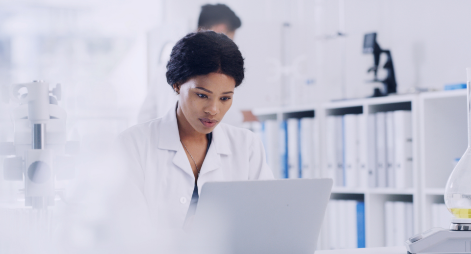 A clinical researcher looks at their computer
