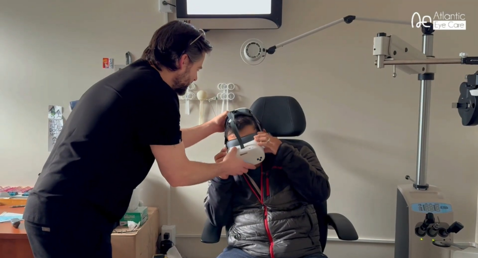A doctor fits a patient with a Carrot headset