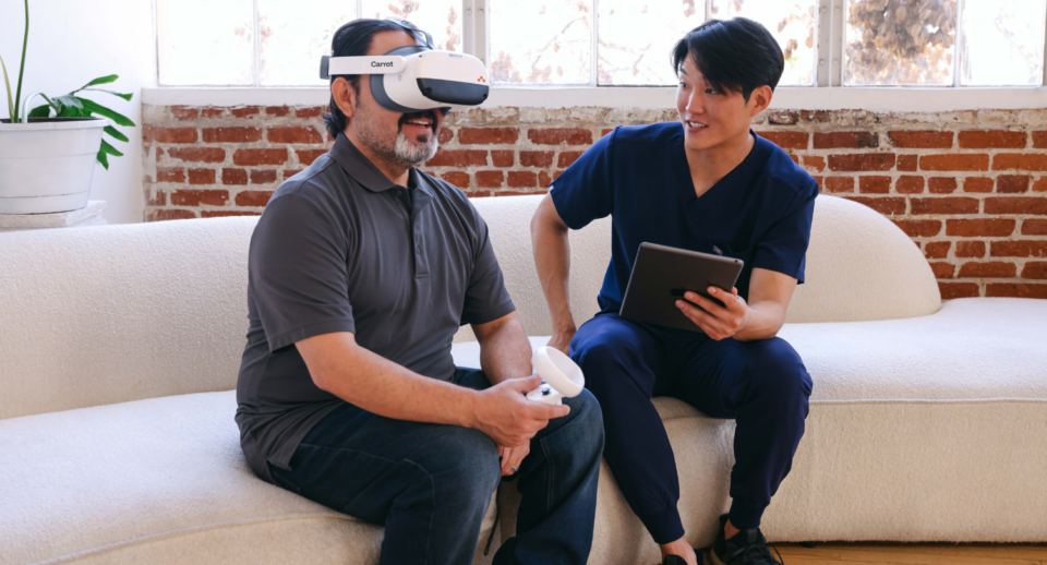 A technician helps a patient take a Carrot Visual Field Test