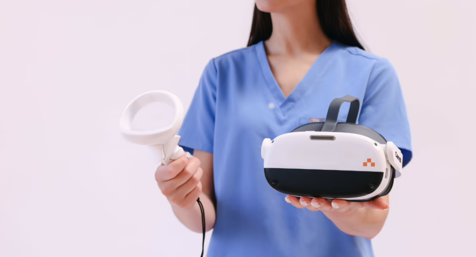 A technician holds a Carrot headset and controller.