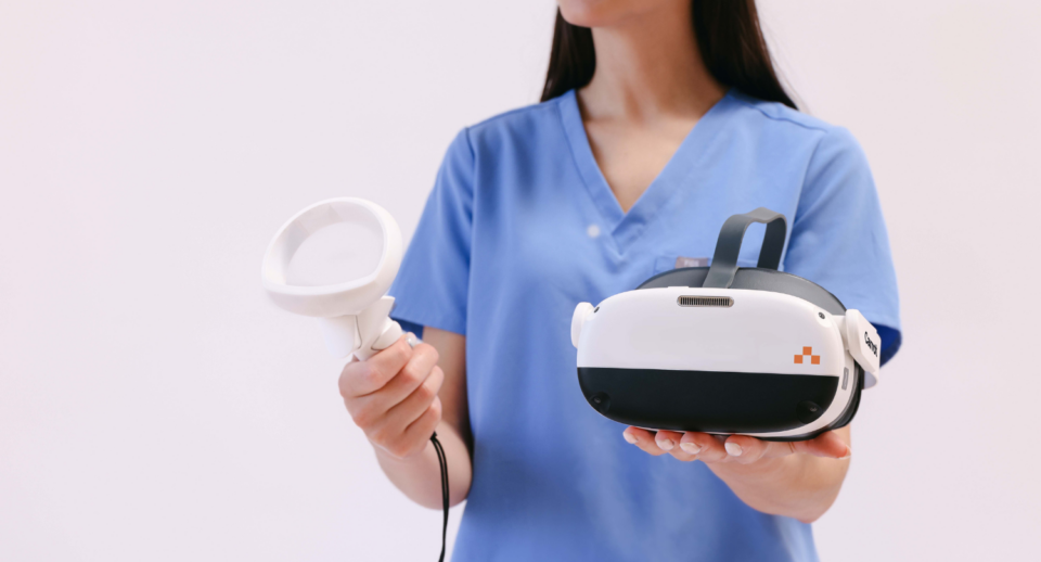 A technician holds a Carrot headset and controller.