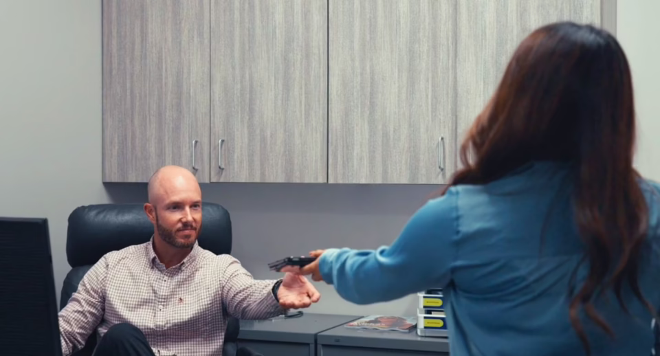 A technician hands a doctor a table with visual field test results